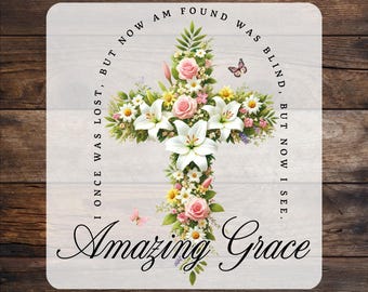 May include: A white background with a floral cross design and the text "I once was lost, but now am found. Was blind, but now I see. Amazing Grace."  The text is in a black font.  The cross is made of white lilies and pink roses with green leaves.  The background is a light wood grain.