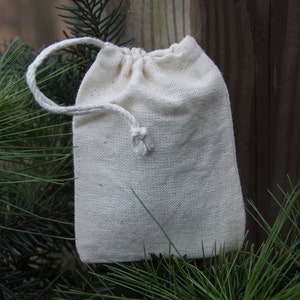 Puede incluir: Una peque&ntilde;a bolsa de algod&oacute;n blanco con cord&oacute;n de ajuste y textura de lino natural. La bolsa est&aacute; vac&iacute;a y tiene un dise&ntilde;o sencillo.