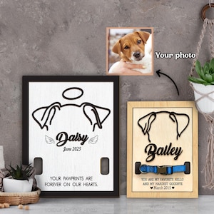 May include: Two wooden pet memorial plaques. One is black-framed with the name "Daisy" and the text "Your pawprints are forever on our hearts." The other is wood-framed with the name "Bailey" and a blue collar design. A photo of a dog is above.
