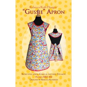 May include: A sewing pattern for a retro-style apron called "Gussie" by Rebecca Ruth Designs. The pattern is for size RRD 302 and is designed by Rebecca Anderson. The apron is shown in a floral print with red trim.