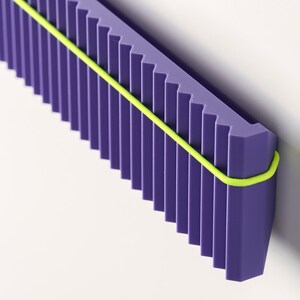 May include: A geometric, abstract design featuring a purple, ridged structure with a neon yellow band wrapped around it. The object is set against a white background, creating a modern aesthetic.