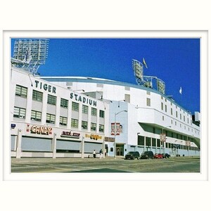 May include: An exterior view of Tiger Stadium, a white building with a blue sky in the background. The stadium has a large sign that reads "Tiger Stadium".