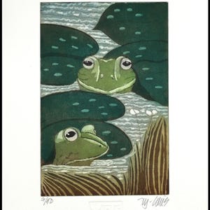 May include: A green frog peeking out from behind a lily pad in a pond. Another frog is visible in the background. The image is a woodblock print with the artist's signature and the number 4/100.