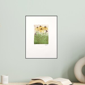 May include: A framed print of a botanical illustration featuring four yellow coneflowers with green leaves and stems. The print is titled "Summer Flowers" and is signed by the artist.