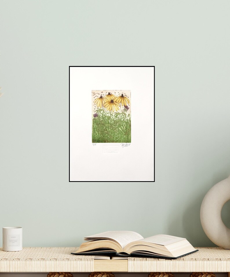 May include: A framed print of a botanical illustration featuring four yellow coneflowers with green leaves and stems. The print is titled "Summer Flowers" and is signed by the artist.