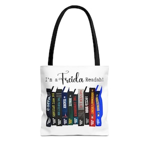 May include: White tote bag with black handles. The bag has a graphic of a stack of books with the text "I'm a Freida Readah!" printed on it.