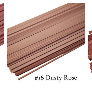 May include: Three bundles of thin wooden strips in different shades of pink. The bundles are labeled #17 Pink, #18 Dusty Rose, and #19 Rosewood Pink.