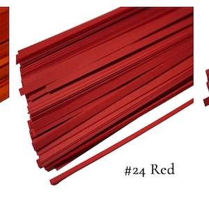 May include: Three bundles of paper strips in different shades of red. The bundles are labeled #23 Orange, #24 Red, and #25 Dark Red.