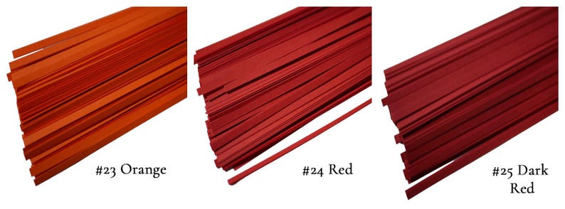 May include: Three bundles of paper strips in different shades of red. The bundles are labeled #23 Orange, #24 Red, and #25 Dark Red.