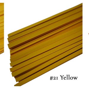 May include: Three bundles of paper strips in different shades of yellow. The bundles are labeled #20 Light Yellow, #21 Yellow, and #22 Tangerine.