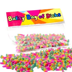 May include: A clear bag of colourful gummy sweets shaped like penises. The sweets are a mix of pink, yellow, and green. The bag has a label that reads "Ballsy Bag of Dicks" in a playful font.