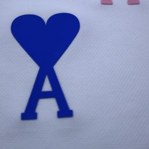 May include: A blue heart with a blue letter A inside, on a white background.