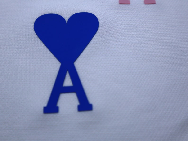May include: A blue heart with a blue letter A inside, on a white background.