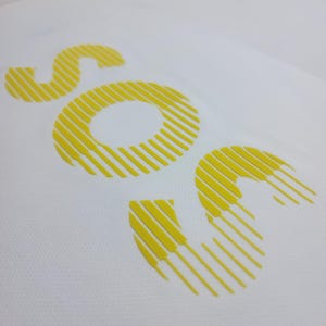 May include: A white background with a yellow logo that says "SOC" in a stylized font. The letters are made up of thin, vertical lines.