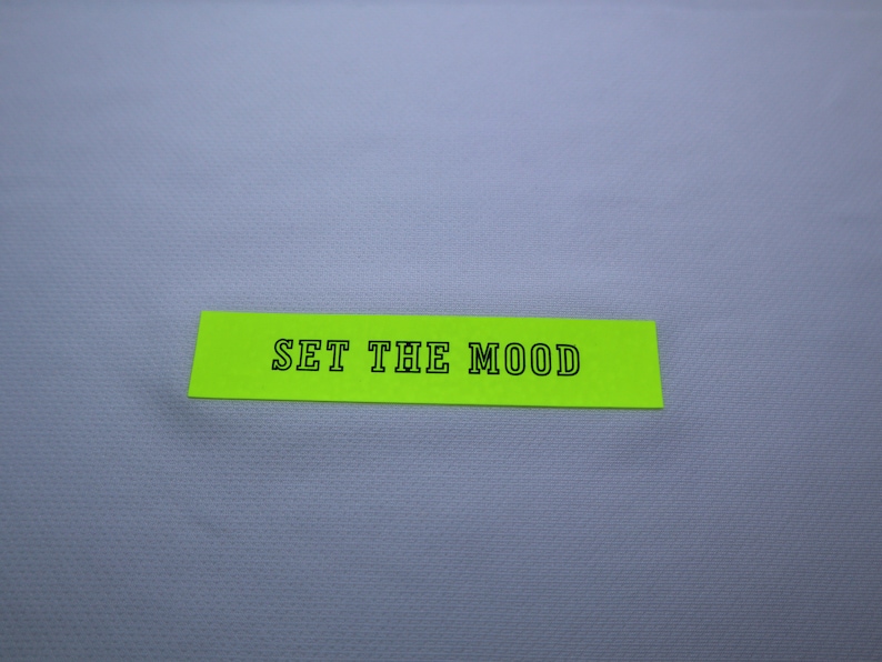 May include: A bright green sticky note with the text "SET THE MOOD" written in black.