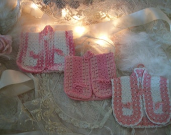 3 vintage hand crocheted pot grabbers, shaped like little vests, vintage kitchen, shades of pink and cream vintage hand craft, hanging
