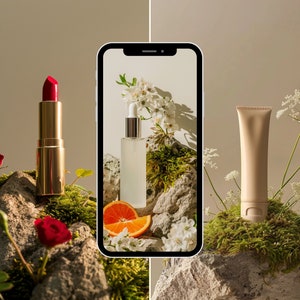 May include: A close-up of a smartphone screen displaying a white bottle of serum, a red lipstick, and a tube of face cream. The products are arranged on a bed of moss and rocks, with white flowers and a slice of orange.