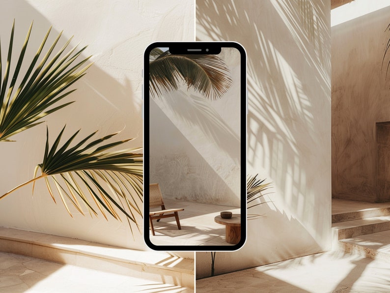 May include: A smartphone displaying a photo of a minimalist interior with a wooden chair and a small table. The photo is taken from a low angle, showing the shadows of palm leaves on the wall.