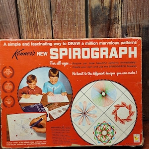 May include: Vintage Kenner Spirograph set in a red and white box. The box features illustrations of children using the Spirograph and examples of the patterns it creates. Text on the box reads "A simple and fascinating way to DRAW a million marvelous patterns."