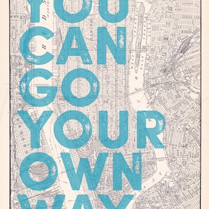 May include: Vintage map of Lower Manhattan with the text "YOU CAN GO YOUR OWN WAY" in large, turquoise letters overlaid. The map is detailed, showing streets, rivers, and the surrounding area. The text is slightly distressed.