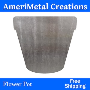 May include: A silver metal flower pot with a slightly textured surface.  The pot is shaped like a traditional flower pot with a wide top and a narrow bottom.  Free Shipping.