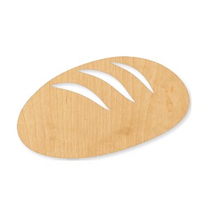 May include: A flat, oval-shaped wooden cutout in the form of a loaf of bread. The light-colored wood features a natural grain pattern and includes three diagonal, curved cutouts across the top surface to represent the score marks on bread.
