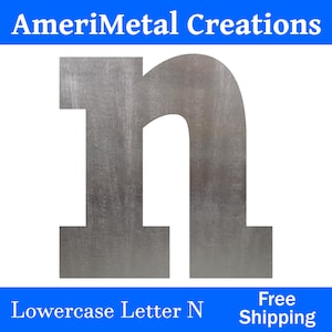 May include: A lowercase letter "n" made of metal with a brushed silver finish. The letter is cut out of a sheet of metal and has a slightly raised edge. The letter is isolated on a white background.