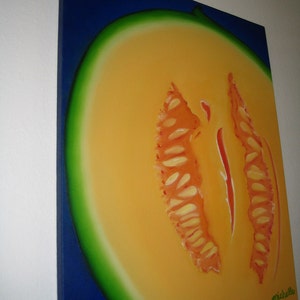 May include: A painting of a cantaloupe melon cut in half, showing the orange flesh and seeds. The melon is painted on a blue background with a green rind.