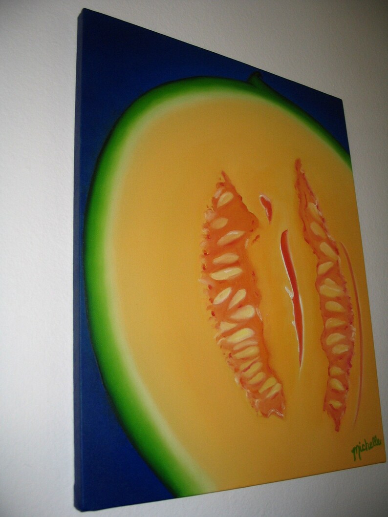 May include: A painting of a cantaloupe melon cut in half, showing the orange flesh and seeds. The melon is painted on a blue background with a green rind.