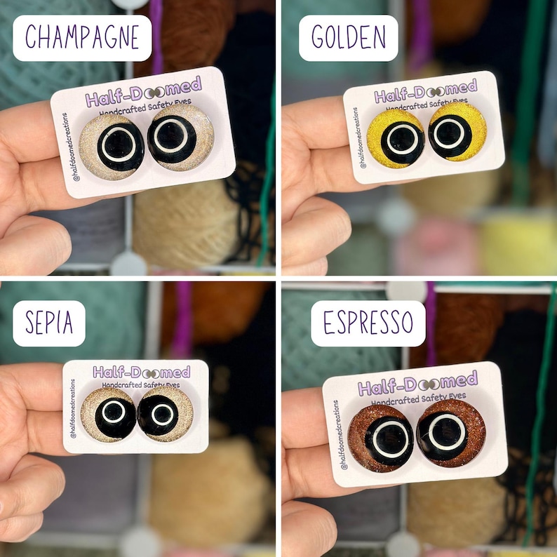 May include: Four sets of handcrafted safety eyes on white display cards labeled Half-Doomed. The colors include champagne, golden, sepia, and espresso. Each pair features a round, glittery iris with a large black pupil and a white ring accent.