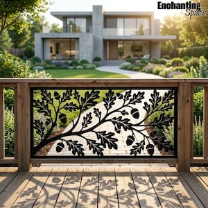 May include: A black metal railing panel featuring a laser-cut design of oak leaves and acorns. The rectangular panel is mounted within a wooden frame on a deck, casting a detailed shadow of the botanical pattern onto the wooden floorboards.