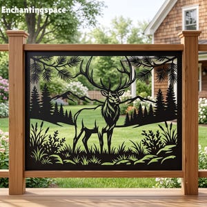 May include: A black metal decorative panel featuring a laser-cut silhouette of a stag with large antlers standing in a forest landscape with pine trees, mountains, and tall grasses. The text Enchantingspace is visible in the top left corner.