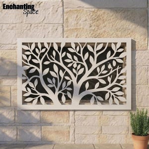 May include: A rectangular white metal wall panel featuring a laser-cut design of a tree with intricate branches and numerous leaves. The panel has a solid frame and a cutout pattern that allows light to pass through the negative space of the tree.