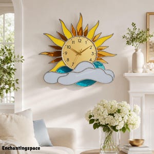 May include: A sun-shaped wall clock featuring a gold-toned circular face with black numerals and hands. The sun rays are crafted from yellow and amber stained glass, while the base consists of light blue and white glass clouds with metal borders.