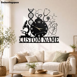 May include: A black wall clock featuring a circular face with gold hands, surrounded by scientific silhouettes including a microscope, DNA helix, stethoscope, and human heart. The text CUSTOM NAME is displayed in a bold font at the base.