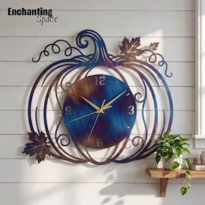 May include: A metal wall clock shaped like a pumpkin with a blue and bronze heat-treated finish. The circular clock face features gold-colored hands and numbers at 12, 3, 6, and 9. The pumpkin frame includes decorative swirling vines and two metal leaves.