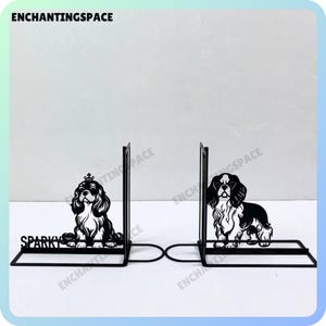 May include: Black metal bookends featuring a silhouette of a Cavalier King Charles Spaniel dog on each side. The bookends are labeled "Sparky" on the left side.