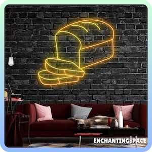 May include: A neon sign depicting a loaf of bread and two slices of bread. The sign is yellow and is set against a dark brick wall.