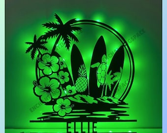 May include: A black silhouette of a tropical scene with palm trees, surfboards, a pineapple, and a turtle. The scene is illuminated with green lights and the name "Ellie" is written below.