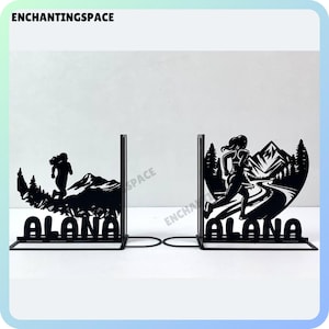 May include: Black metal bookends featuring a silhouette of a person running through a mountain landscape. The bookends are personalised with the name "Alana".
