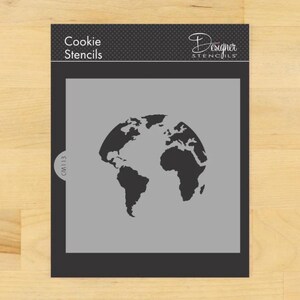 May include: A gray cookie stencil featuring a black silhouette of the Earth. The stencil is labeled "Cookie Stencils" and "Designer Stencils" at the top. The stencil number "CM1113" is printed in the lower left corner.