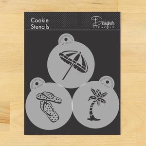 May include: A set of three cookie stencils featuring a palm tree, flip flops, and an umbrella. The stencils are white and are on a black background. The text "Cookie Stencils" and "Designer Stencils" is printed on the background.
