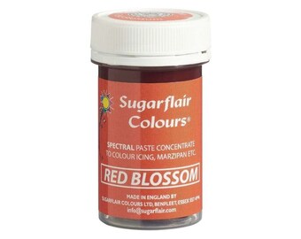 May include: A small jar of red food coloring called "Red Blossom" by Sugarflair Colours. The jar is labeled "Spectral Paste Concentrate to Colour Icing, Marzipan etc."