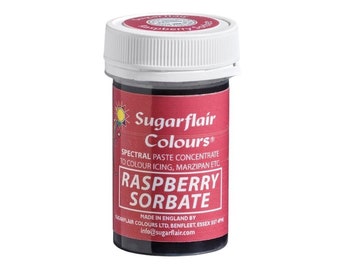 May include: A small, round jar of red raspberry-flavored food coloring. The jar is labeled "Sugarflair Colours® Spectral Paste Concentrate to Colour Icing, Marzipan etc. Raspberry Sorbate Made in England by Sugarflair Colours Ltd. Benfleet, Essex SS7 4PW info@sugarflair.com"