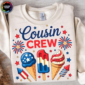 May include: Cream-colored sweatshirt with the words "Cousin Crew" in blue and red, decorated with red and blue stars, fireworks, and ice cream cones. The ice cream cones are red, white, and blue.