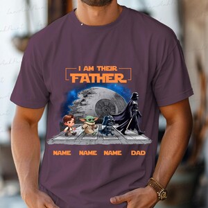 May include: Purple t-shirt featuring a Star Wars design with the text "I AM THEIR FATHER." The graphic includes cartoon characters and the Death Star. Below the characters are the words "NAME NAME NAME DAD."