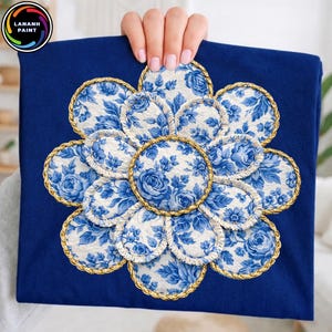 May include: A navy blue fabric with a large floral design. The design features white and blue floral patterns, with a gold trim. The design is in the shape of a flower. The logo "LANANH PAINT" is in the upper left corner.