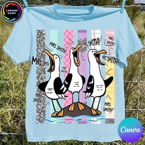 May include: A light blue t-shirt featuring a graphic of three white and black seagulls standing on a rock. Each seagull has an open beak and the text "MRS. SMITH!" is repeated multiple times around them. The background consists of vertical stripes.