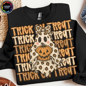 May include: A black sweatshirt featuring a repeating background pattern of the text TRICK OR TREAT in orange and white. Centered is a ghost illustration wearing a leopard print bow, holding an orange jack-o'-lantern pumpkin with a stem.