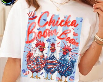 May include: White t-shirt with a patriotic design featuring three rooster illustrations in red, white, and blue. The text "Chicka Boom Boom" is in red script. The design includes stars, stripes, and a top hat.